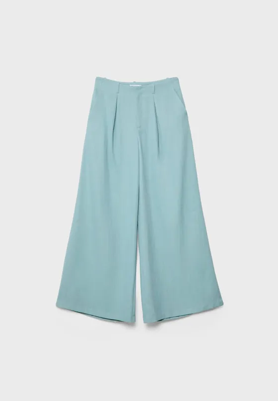 Брюки из струящейся рельефной ткани с защипами