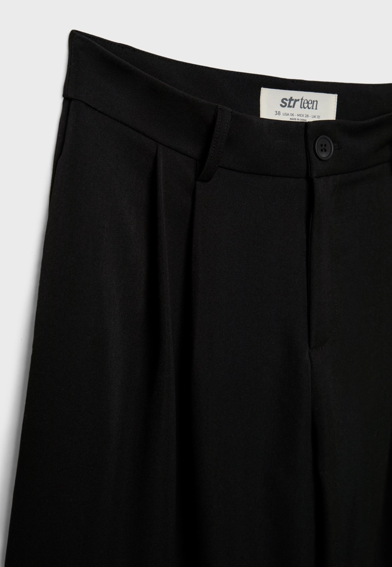 Классические брюки свободного кроя с защипами